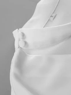 Chemisier péplum blanc élégant pour femme - Col V dos nu manches lanternes coupe ajustée - Idéal pour le printemps et le soir (2026)