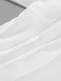 Chemisier péplum blanc élégant pour femme - Col V dos nu manches lanternes coupe ajustée - Idéal pour le printemps et le soir (2026)