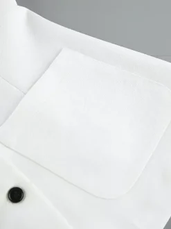Ensemble deux pièces : boutons blancs col rond chic jupe sans manches.