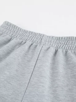 Ensemble lounge gris chiné : haut oversize à manches courtes et taille élastique pantalon large.