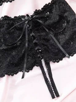 Ensemble soutien-gorge et culotte deux pièces en dentelle noire à fleurs sans entrejambe et sans bonnets avec n艙ud sur le devant.