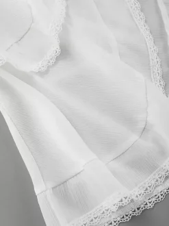 Jupe mini asymétrique à taille élastique et bordure en dentelle à volants