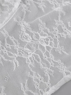 Jupes blanches en dentelle élégantes coupe asymétrique longueur genou bas pour femmes