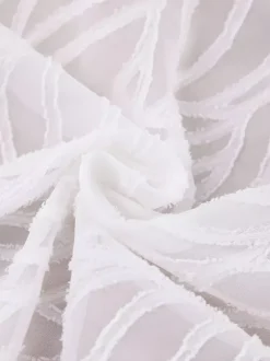 Mini-robe en jacquard à col en V et manches longues pour l'été 2026