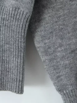 Pull asymétrique à taille côtelée et manches lanternes pour femme (2026)