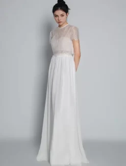 Robe de mariée deux pièces ivoire haut en dentelle col rond boutonné sur dos jupe en tulle