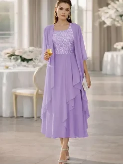 Robe de mère de la mariée deux pièces col rond manches mi-longues coupe trapèze dentelle longueur thé idéale pour un mariage ou une réception.
