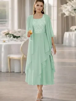 Robe de mère de la mariée deux pièces col rond manches mi-longues coupe trapèze dentelle longueur thé idéale pour un mariage ou une réception.