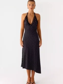 Robe de soirée midi noire à pois dos nu sans manches style semi-formel idéale pour l'été.