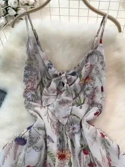 Robe de vacances maxi dos nu à fleurs bretelles fines sans manches imprimé floral col chic couleur abricot