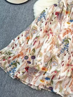 Robe de vacances maxi dos nu à fleurs bretelles fines sans manches imprimé floral col chic couleur abricot