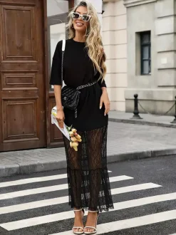 Robe longue blanche élégante en dentelle à manches courtes et col rond idéale pour une soirée romantique.