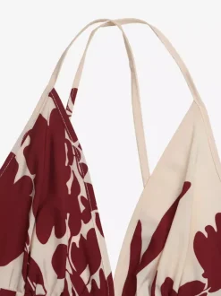 Robe longue fluide à bretelles spaghetti imprimé floral crème bordeaux décolleté en V profond idéale pour l'été et la plage.