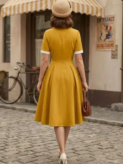 Robe midi élégante à revers rétro et boutons latéraux coupe ajustée et évasée pour femme (collection 2026)
