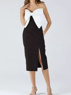 Robe noire chic à bretelles dos nu et sans manches ornée de n艙uds idéale pour une soirée romantique.