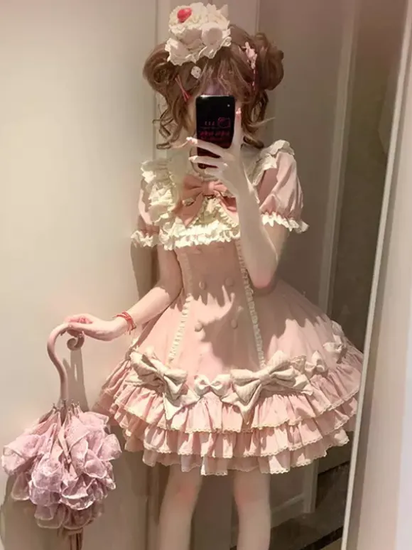 Robe Sweet Lolita rose à manches courtes volants et n艙uds avec chapeau.