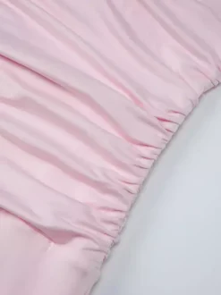 Robe de soirée moulante rose poudré à décolleté plongeant et dos nu froncé