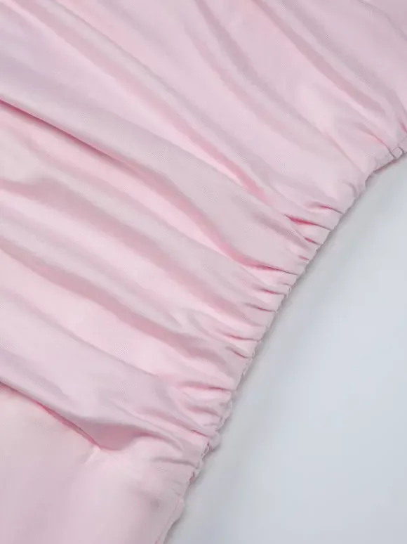 Robe de soirée moulante rose poudré à décolleté plongeant et dos nu froncé