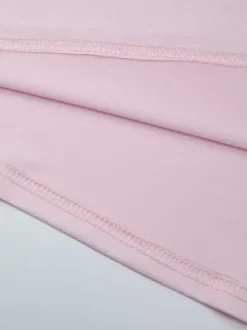 Robe de soirée moulante rose poudré à décolleté plongeant et dos nu froncé