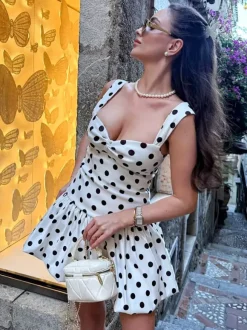Robe d'été blanche décontractée mini dos nu sans manches à pois bretelles et col rond idéale pour une soirée en amoureux.