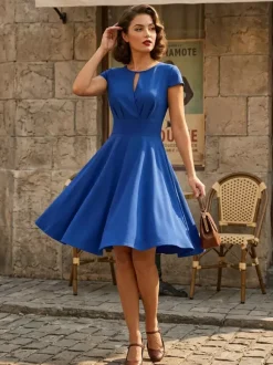 Robe glamour vintage style années 50 col rond manches courtes découpées coupe trapèze moyenne