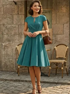 Robe glamour vintage style années 50 col rond manches courtes découpées coupe trapèze moyenne