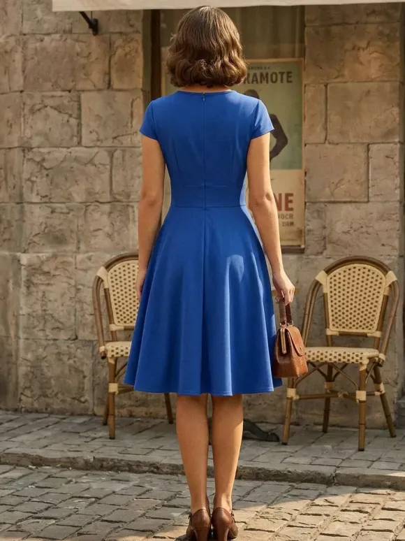 Robe glamour vintage style années 50 col rond manches courtes découpées coupe trapèze moyenne