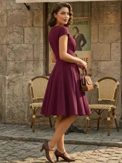 Robe glamour vintage style années 50 col rond manches courtes découpées coupe trapèze moyenne