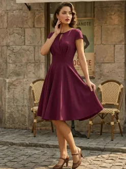 Robe glamour vintage style années 50 col rond manches courtes découpées coupe trapèze moyenne
