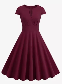 Robe glamour vintage style années 50 col rond manches courtes découpées coupe trapèze moyenne