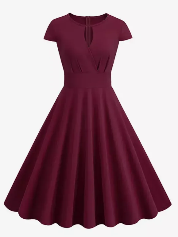Robe glamour vintage style années 50 col rond manches courtes découpées coupe trapèze moyenne