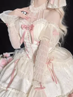 Robe Lolita rose à bretelles sans manches à volants et lacets avec coiffe assortie.
