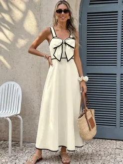 Robe longue dos nu plissée à n艙uds sans manches épaules dénudées couleur écru et blanc doux idéale pour une soirée romantique.