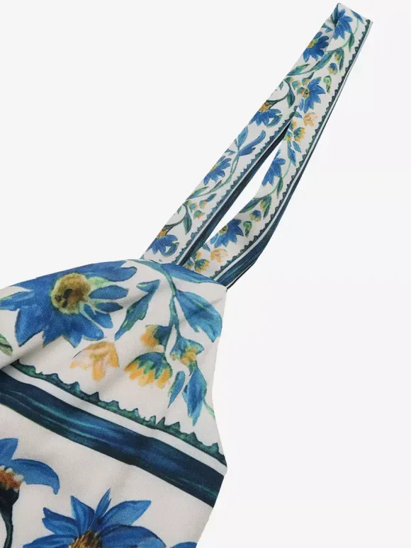 Robe longue d'été fluide à bretelles spaghetti et imprimé floral bleu pour femme avec n艙ud sur le devant et volants.