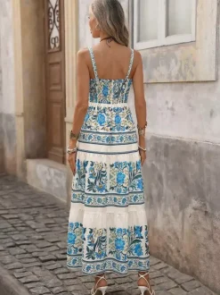 Robe longue d'été fluide à bretelles spaghetti et imprimé floral bleu pour femme avec n艙ud sur le devant et volants.