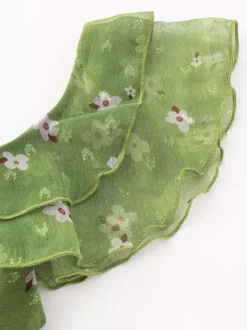 Robe verte sans manches à col en V et taille haute pour femme ornée de fleurs douces.