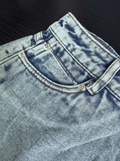 Short en jean taille haute à franges brutes jambes larges coupe trapèze.
